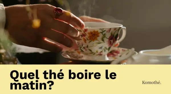 Une main ornée d'une bague saisit une tasse de thé fumante, ornée de fleurs. La question "Quel thé boire le matin?" invite à découvrir le plaisir d'une boisson matinale.