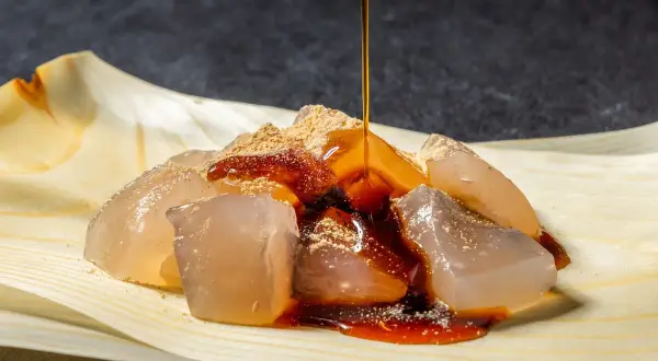 Glace translucide saupoudrée de poudre de soja grillé, nappée de sirop brun. Un délice de warabi mochi.